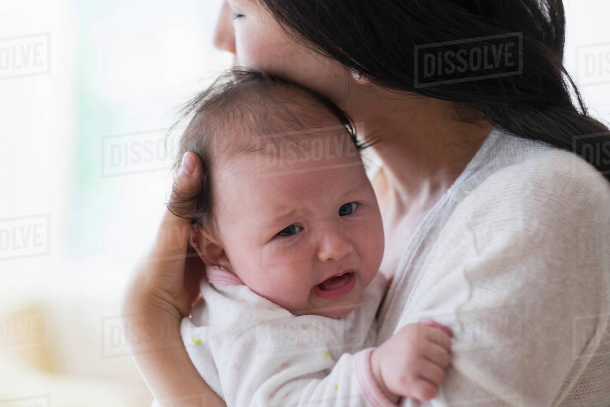 Asian mother comforting crying baby Royalty-free stock photo