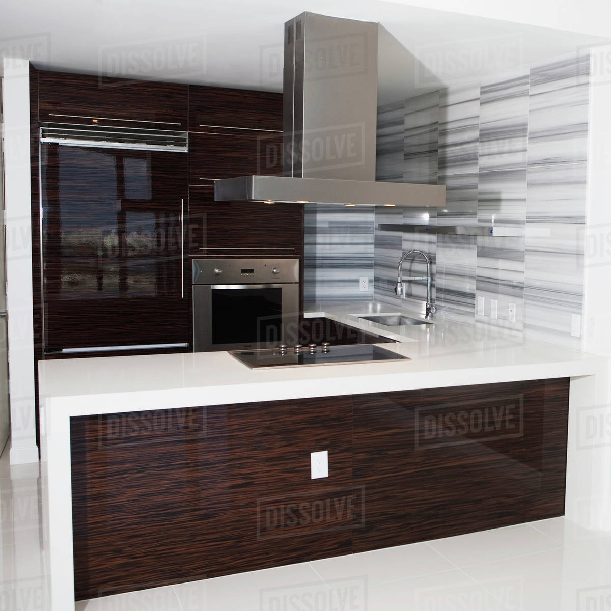 Vent, stove and countertop in empty modern kitchen Stock Photo Dissolve