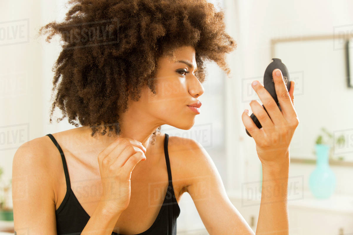 Mixed Race Woman Checking Her Makeup Stock Photo Dissolve