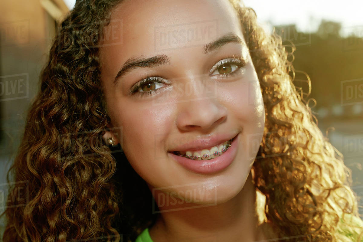 Mixed race girl smiling Stock Photo Dissolve