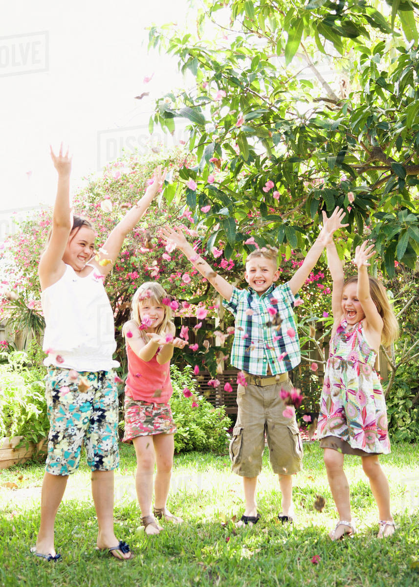 Caucasian children playing in garden - Royalty-free Stock Photo | Dissolve