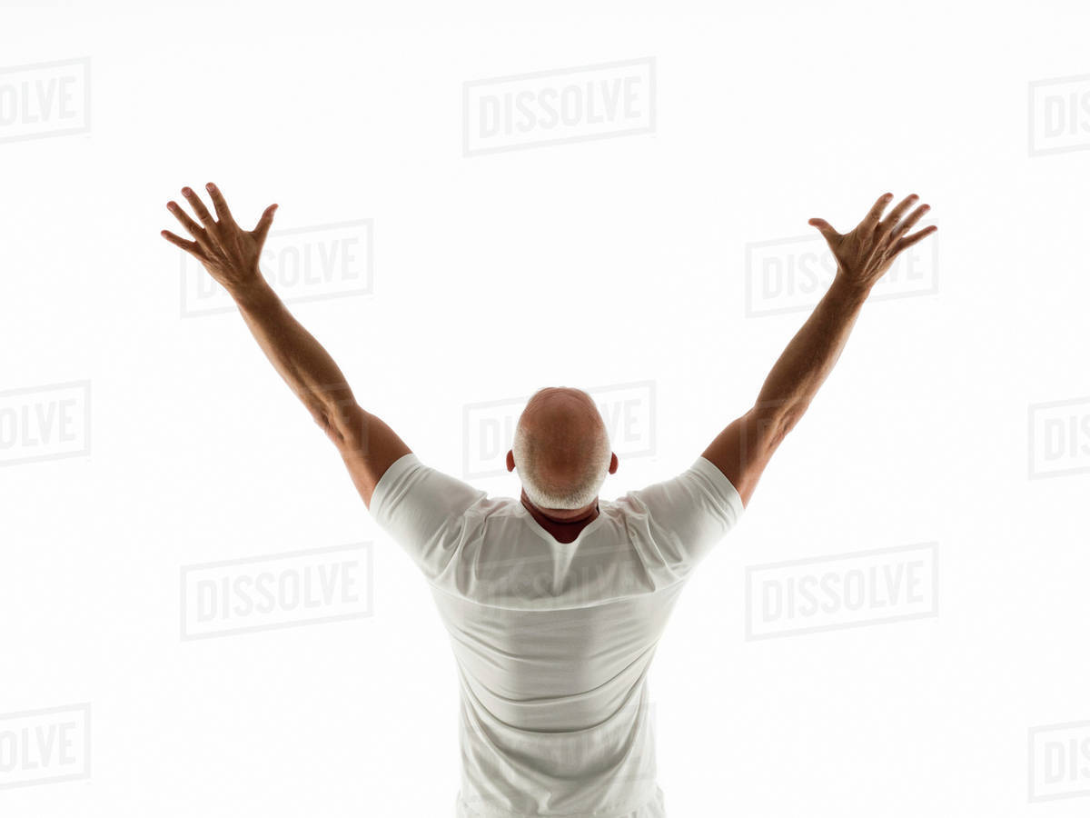 Rear view of older man cheering with arms raised - Royalty-free Stock ...