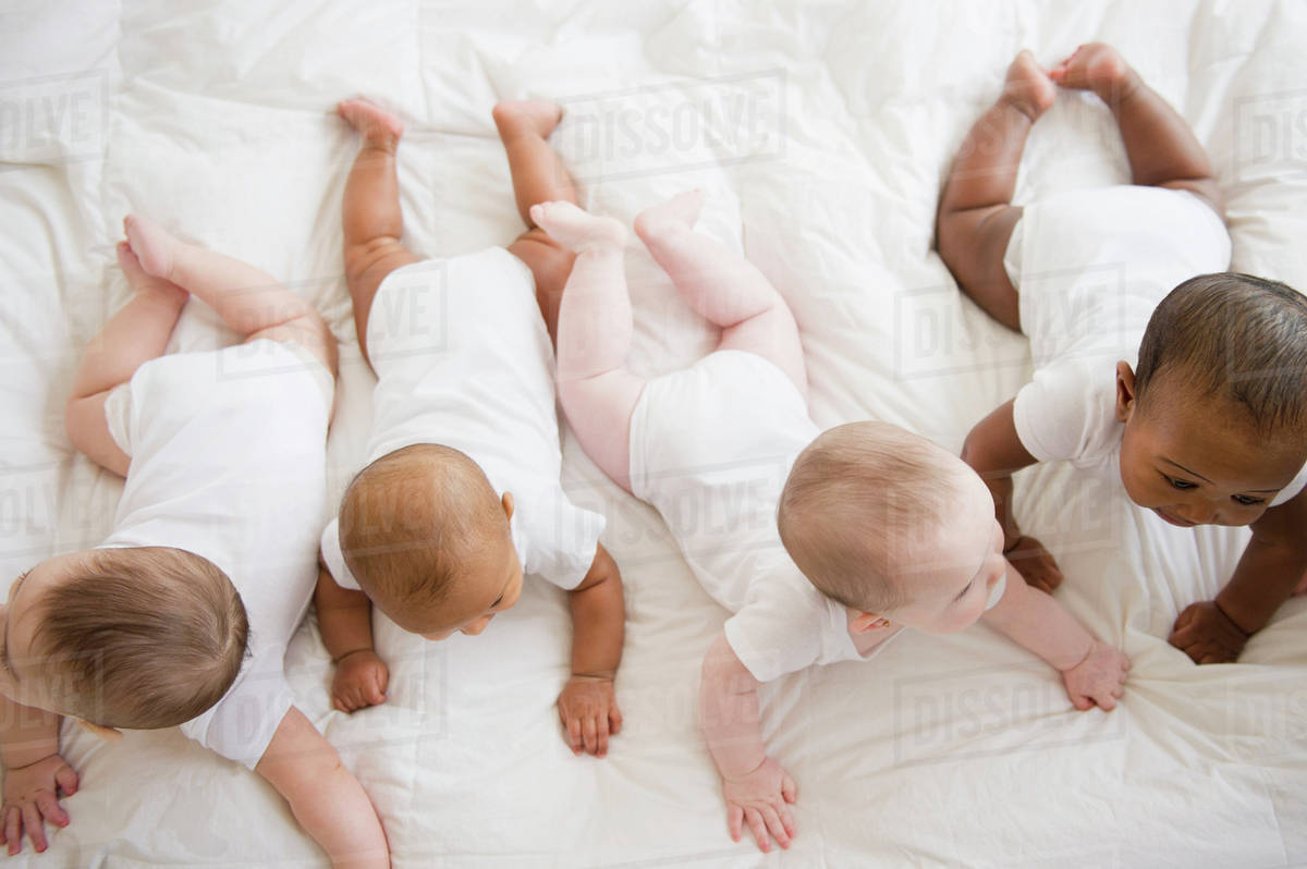 Babies laying on floor together Stock Photo Dissolve