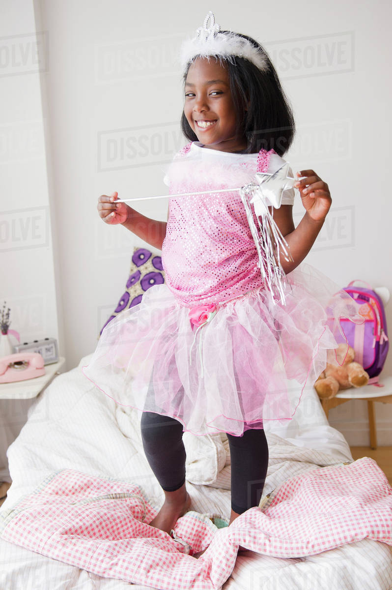 Black girl in fairy costume standing on bed Royalty-free stock photo