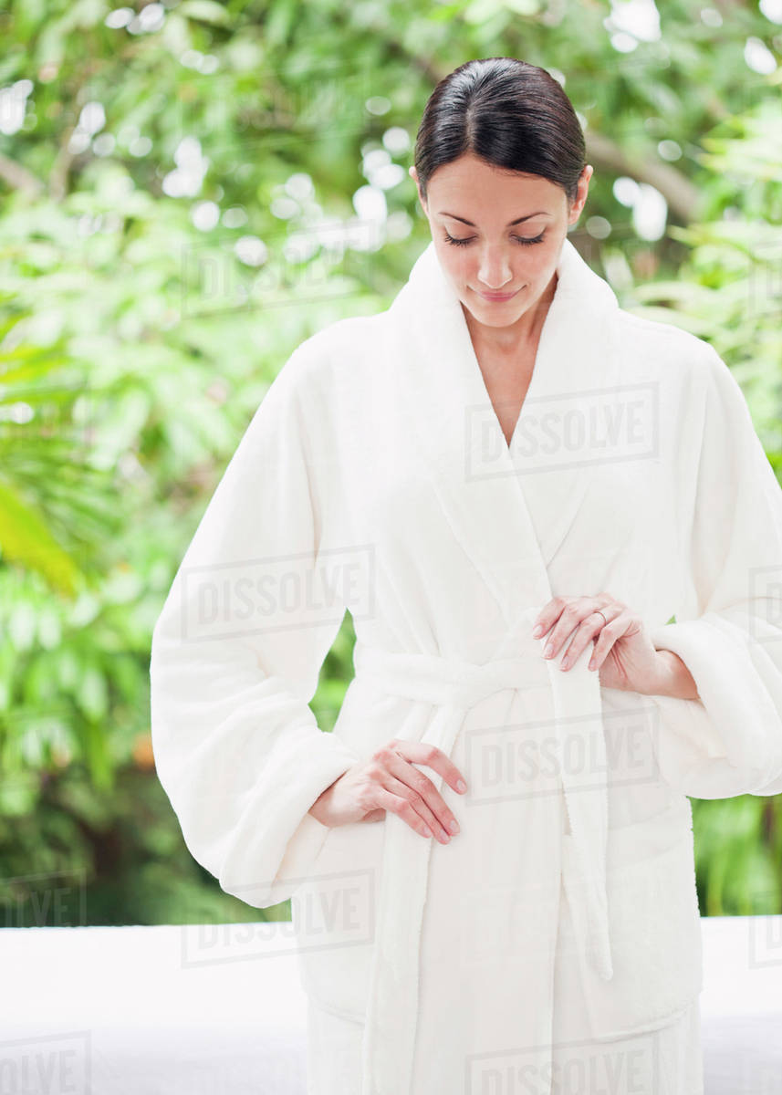 Caucasian woman tying bathrobe Stock Photo Dissolve