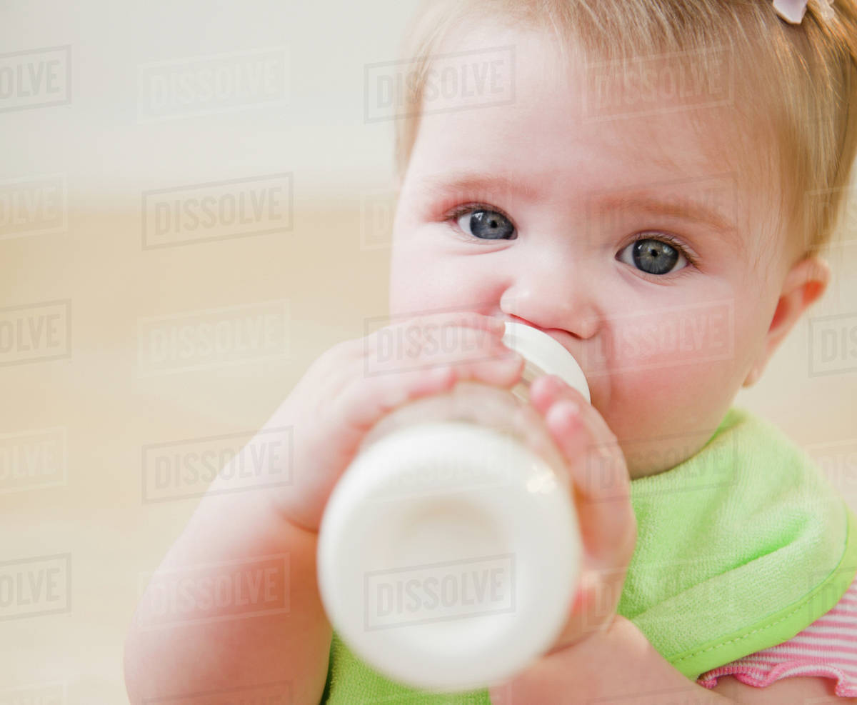 Caucasian baby drinking bottle Stock Photo Dissolve