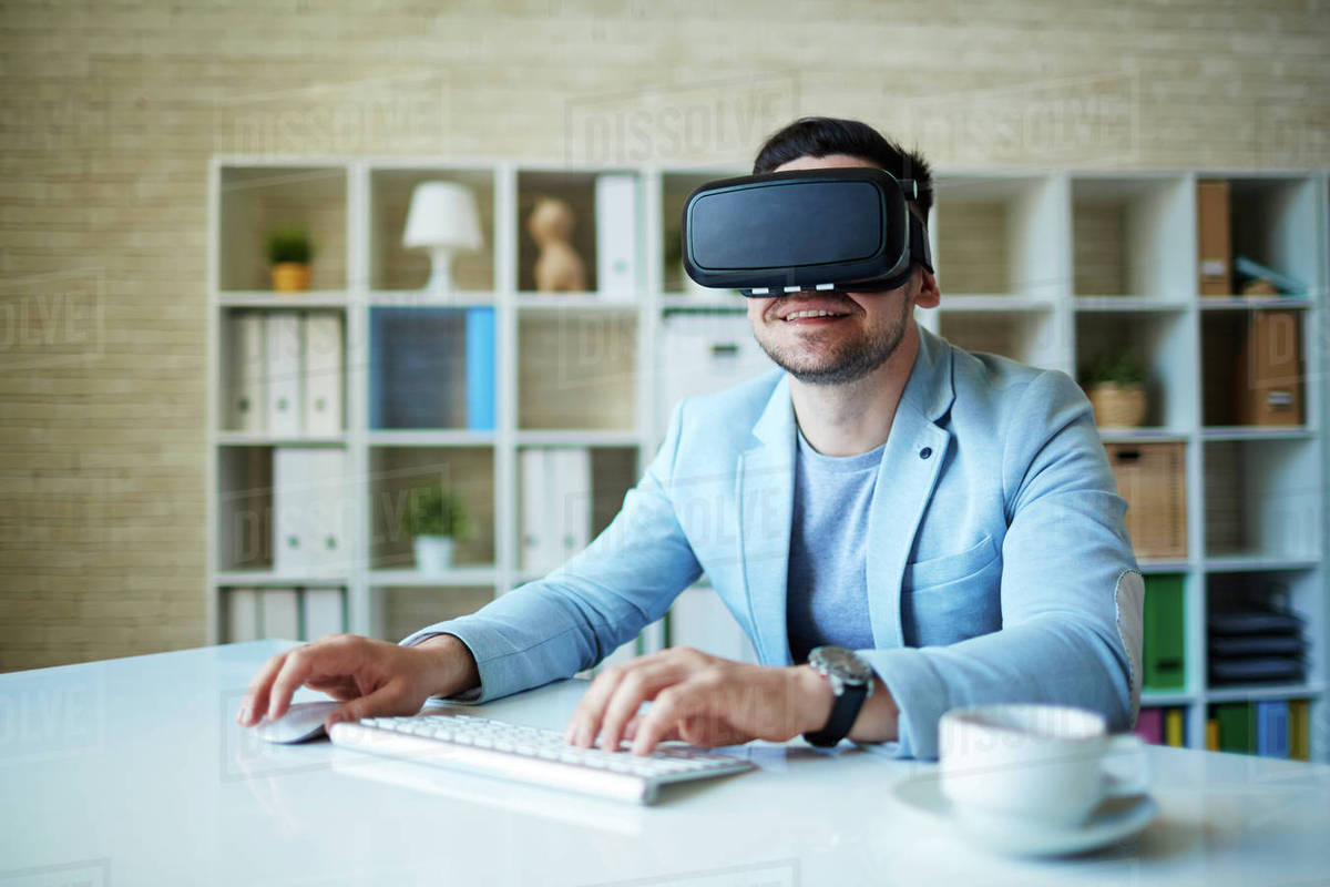 Modern businessman working in virtual reality in office Stock Photo