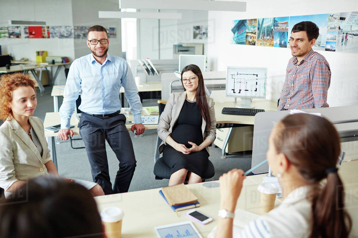 Happy managers chatting at break in office Stock Photo Dissolve