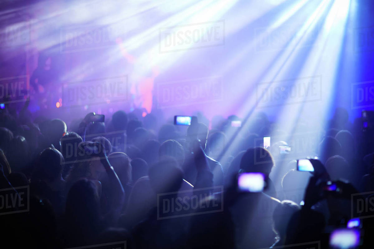 Person in crowd at concert recording with smartphone Royalty-free stock photo