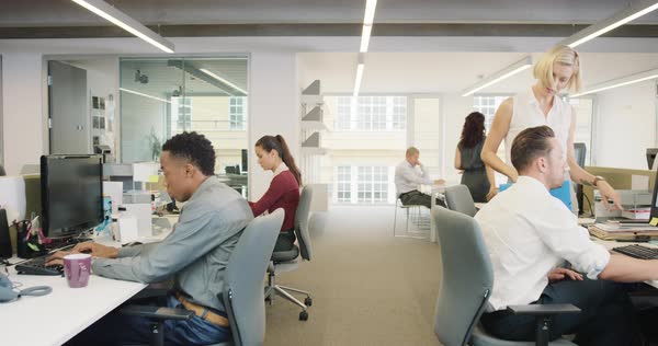 Busy activity in diverse business office with business people working ...