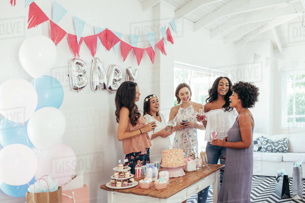 Baby shower. Group of diverse women together at baby shower. Smiling