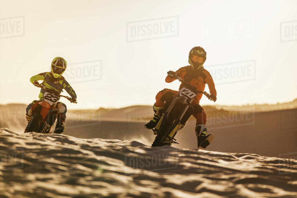 Two motocross racers racing on the off-road circuit. Professional dirt ...