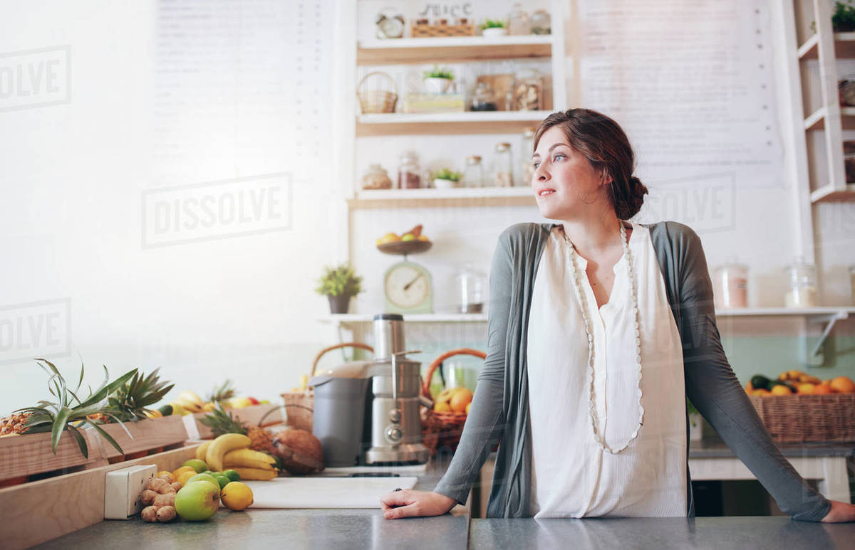 Portrait of attractive young woman standing behind the counter and