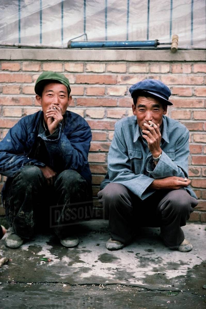do chinese smoke cigarettes Two men smoking cigarettes while squatting on the sidewalk, China -  Royalty-free Stock Photo