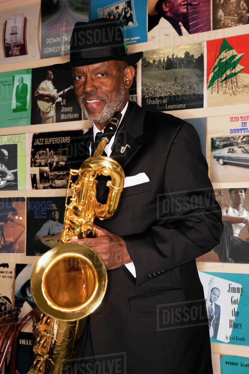 African man holding saxophone Stock Photo Dissolve