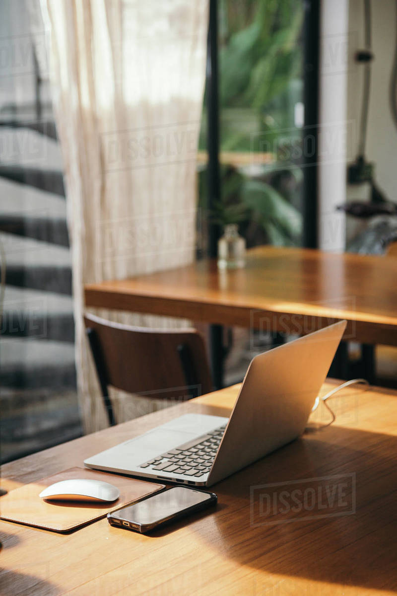 Rustic working table with laptop computer for working from home with sunlight indoor room
