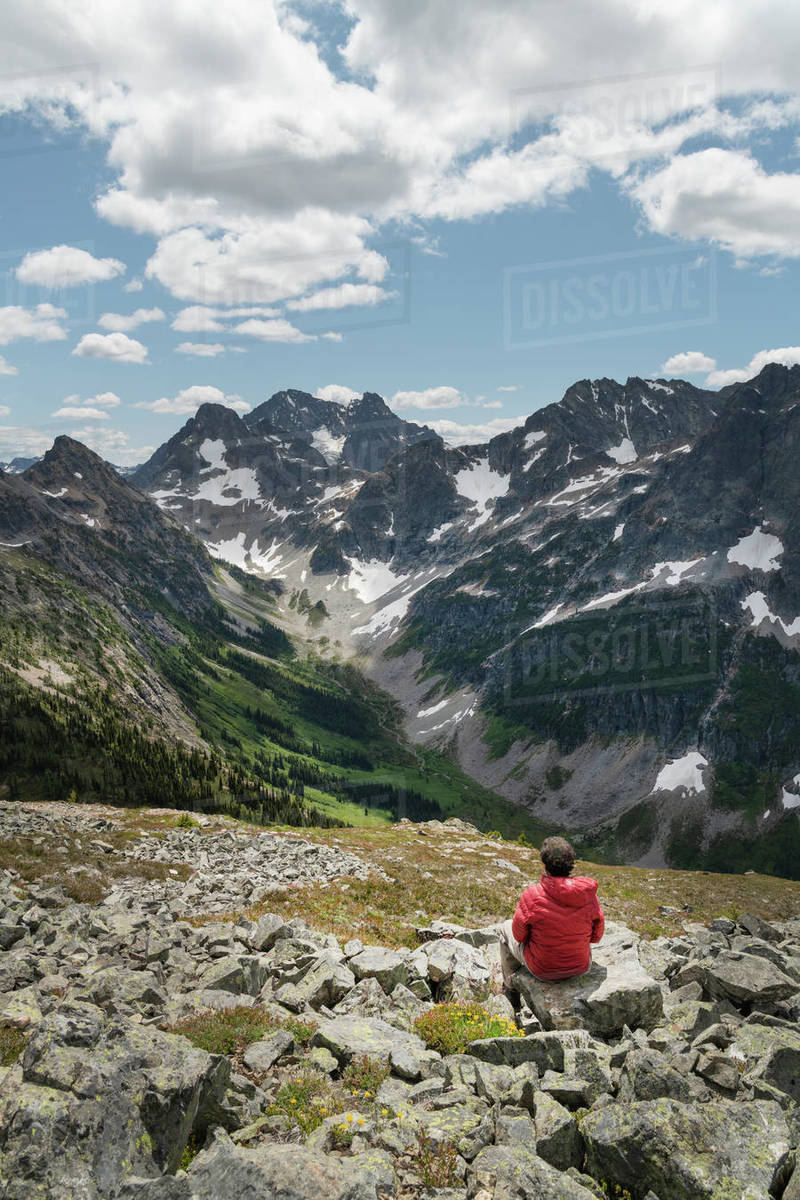Adult male hiker with red jacket on Ragged Ridge taking in the view of ...