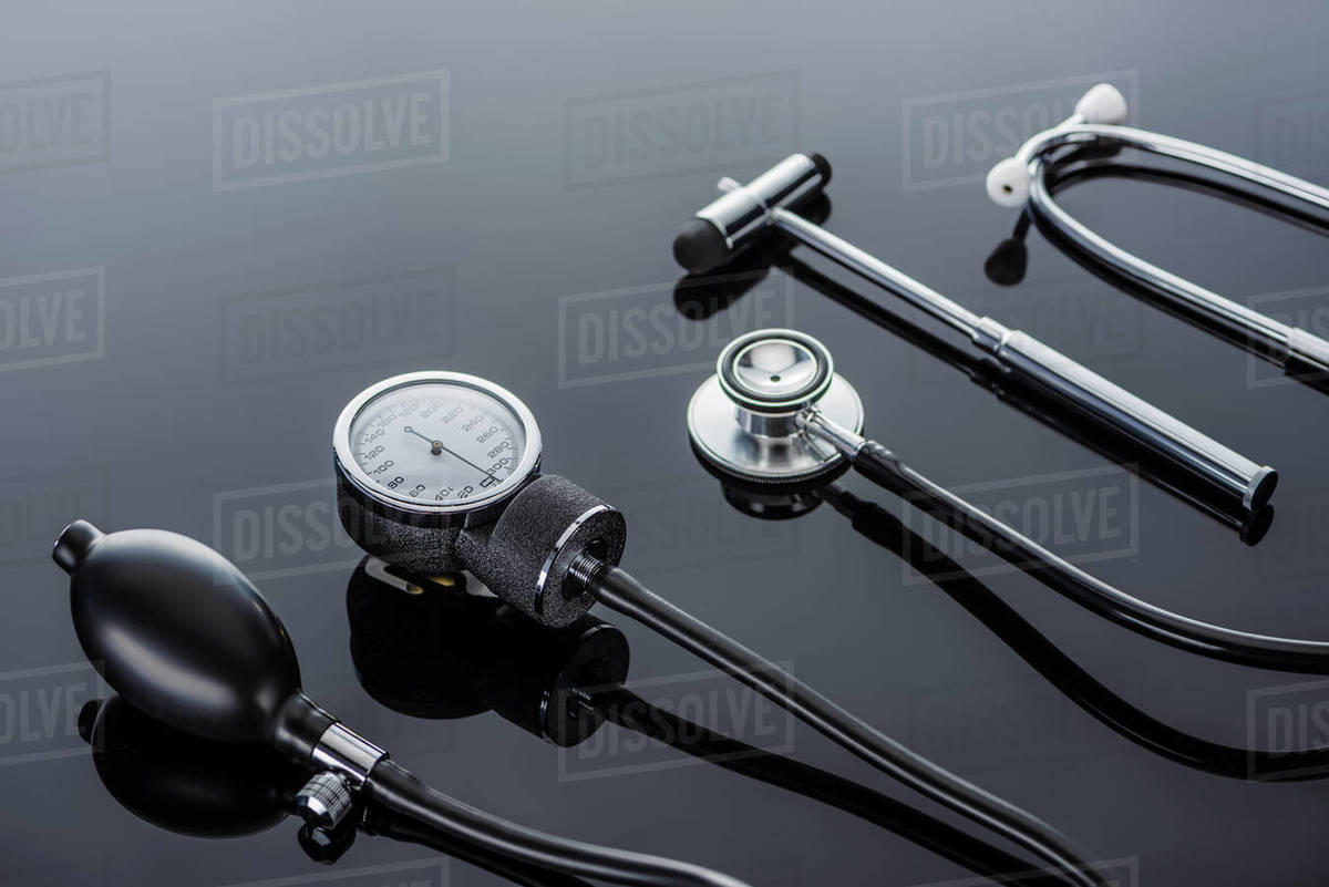 close up view of device for measuring pressure, reflex hammer and