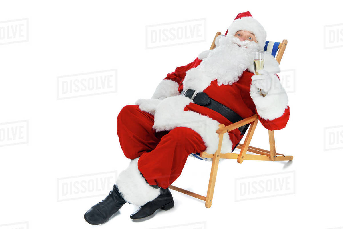 Santa Claus Resting On Beach Chair With Champagne Glass Isolated On White Stock Photo Dissolve