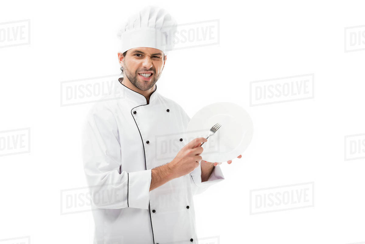 Young chef scratching plate with fork isolated on white Stock Photo