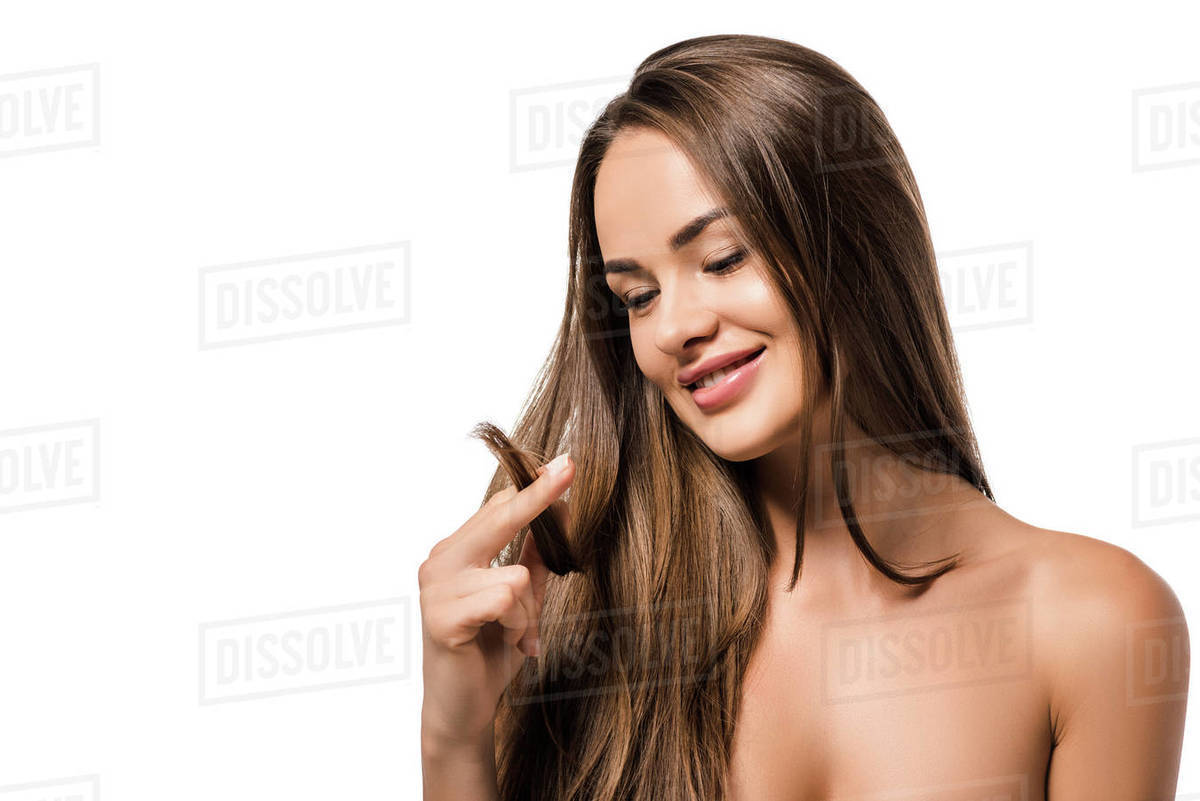 Happy Beautiful Woman Holding Long Brown Hair And Looking At Tips