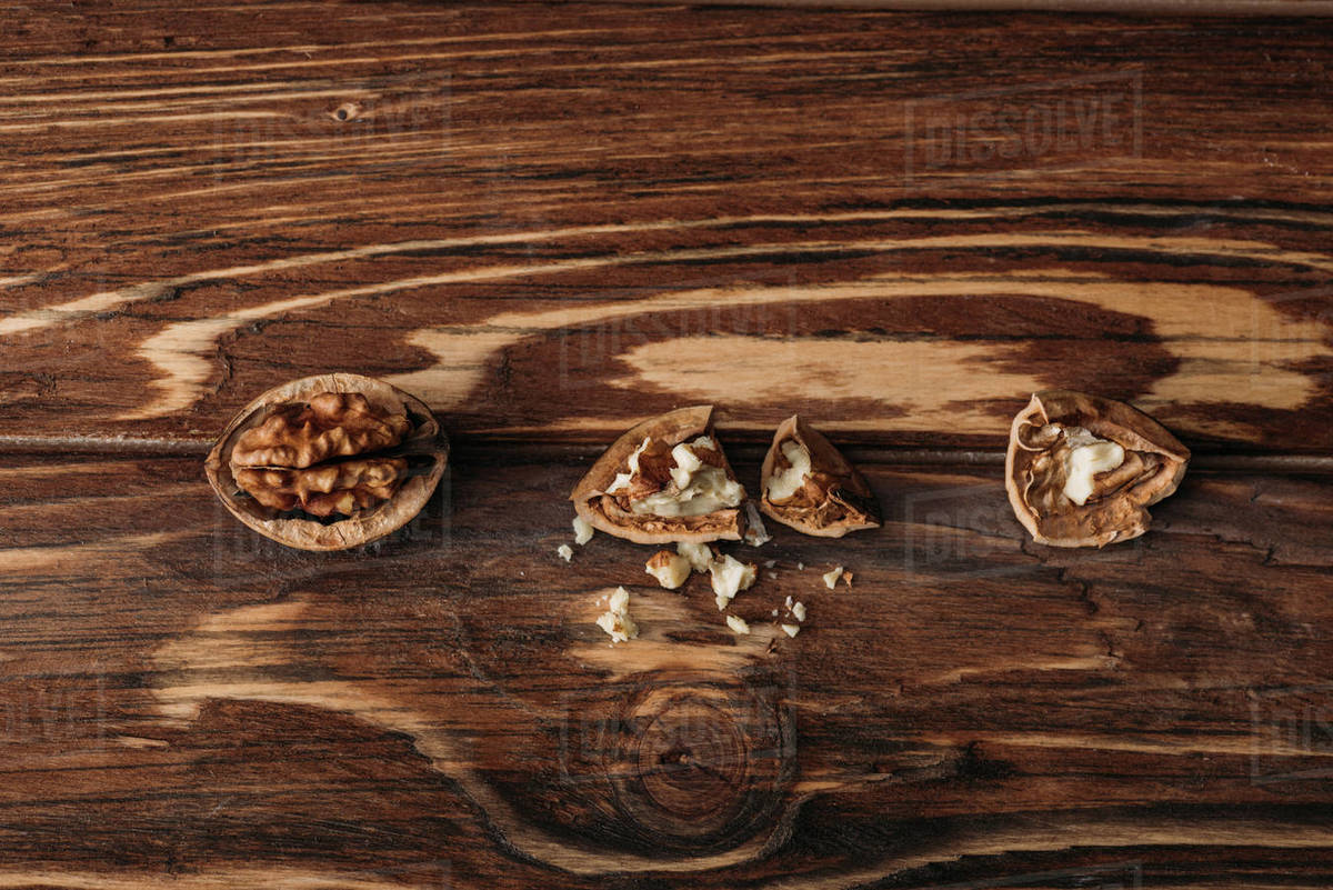 Top view of walnuts in nut shells as dementia symbol on wooden table