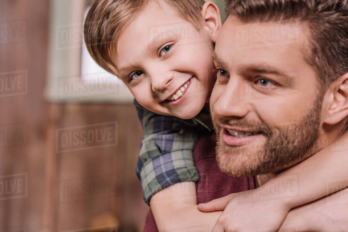 Young father with little son sitting on porch at backyard, dad and son playing Stock Photo