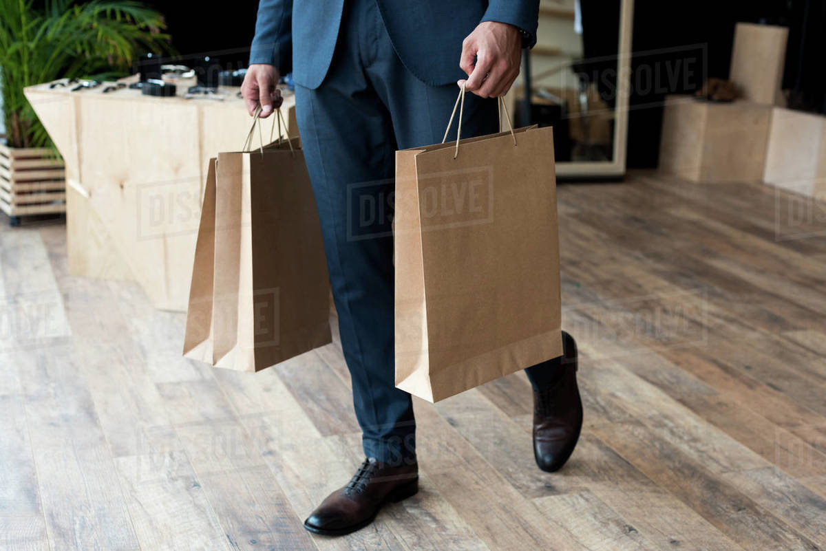 Cropped Shot Of Young Businessman Holding Shopping Bags In