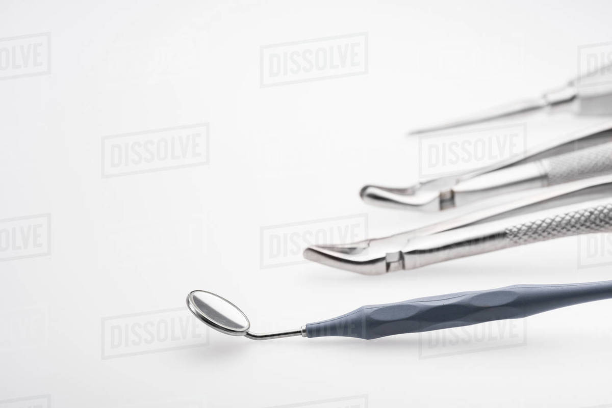 Closeup view of dental mirror and professional dental instruments