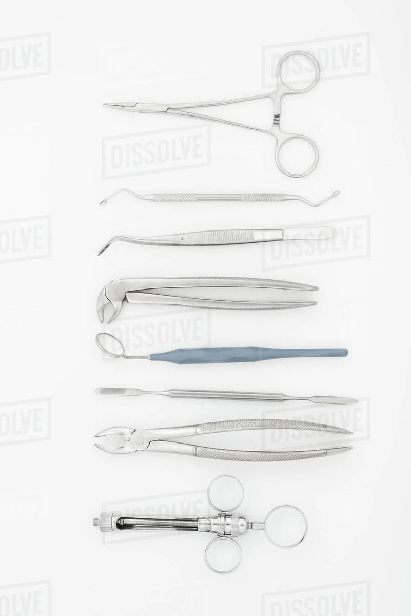 Top view of set of professional dental instruments isolated on white