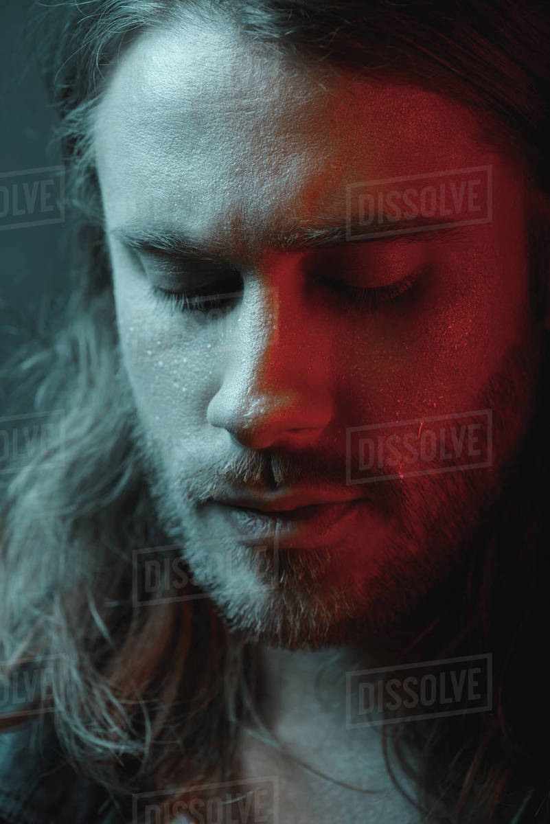 Close Up Portrait Of Pensive Bearded Long Haired Man Looking Down