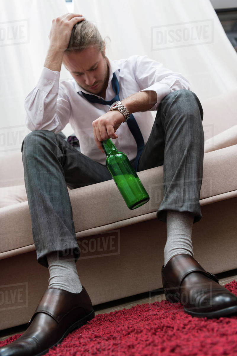 Man having headache after drinking alcohol Stock Photo Dissolve