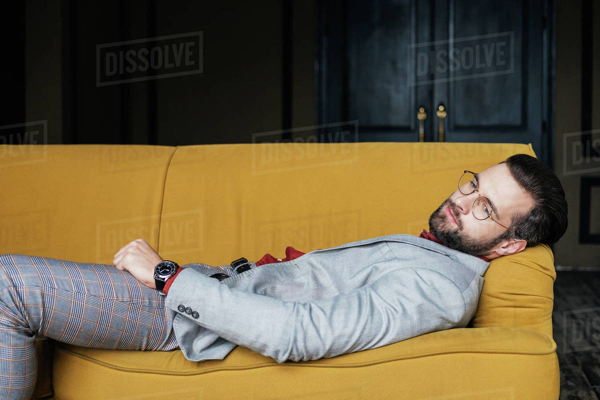 Depressed Elegant Man Resting And Lying On Couch Stock Photo Dissolve