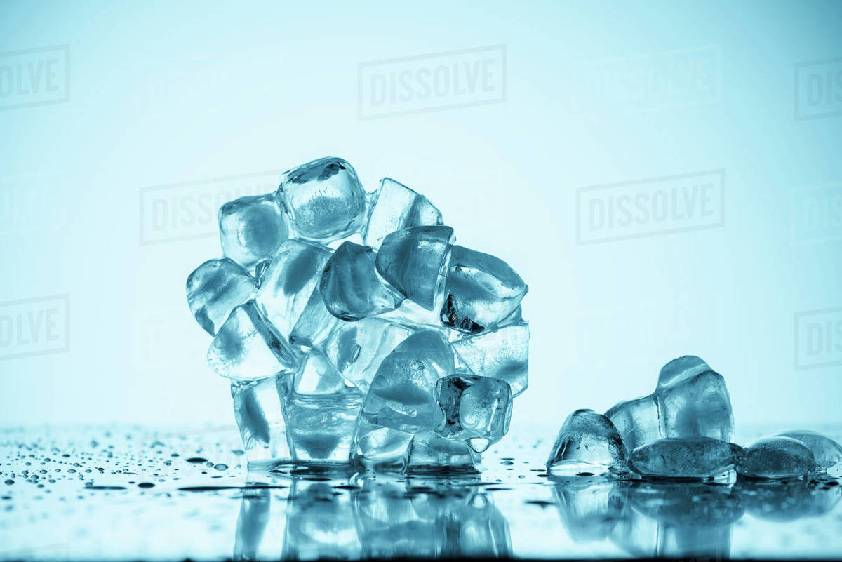 Melting ice cubes on white with drops Stock Photo Dissolve