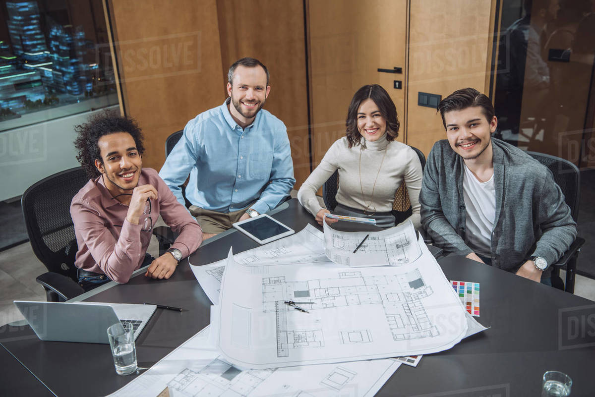 Group of successful architects sitting at conference hall at office and looking at camera Royalty-free stock photo