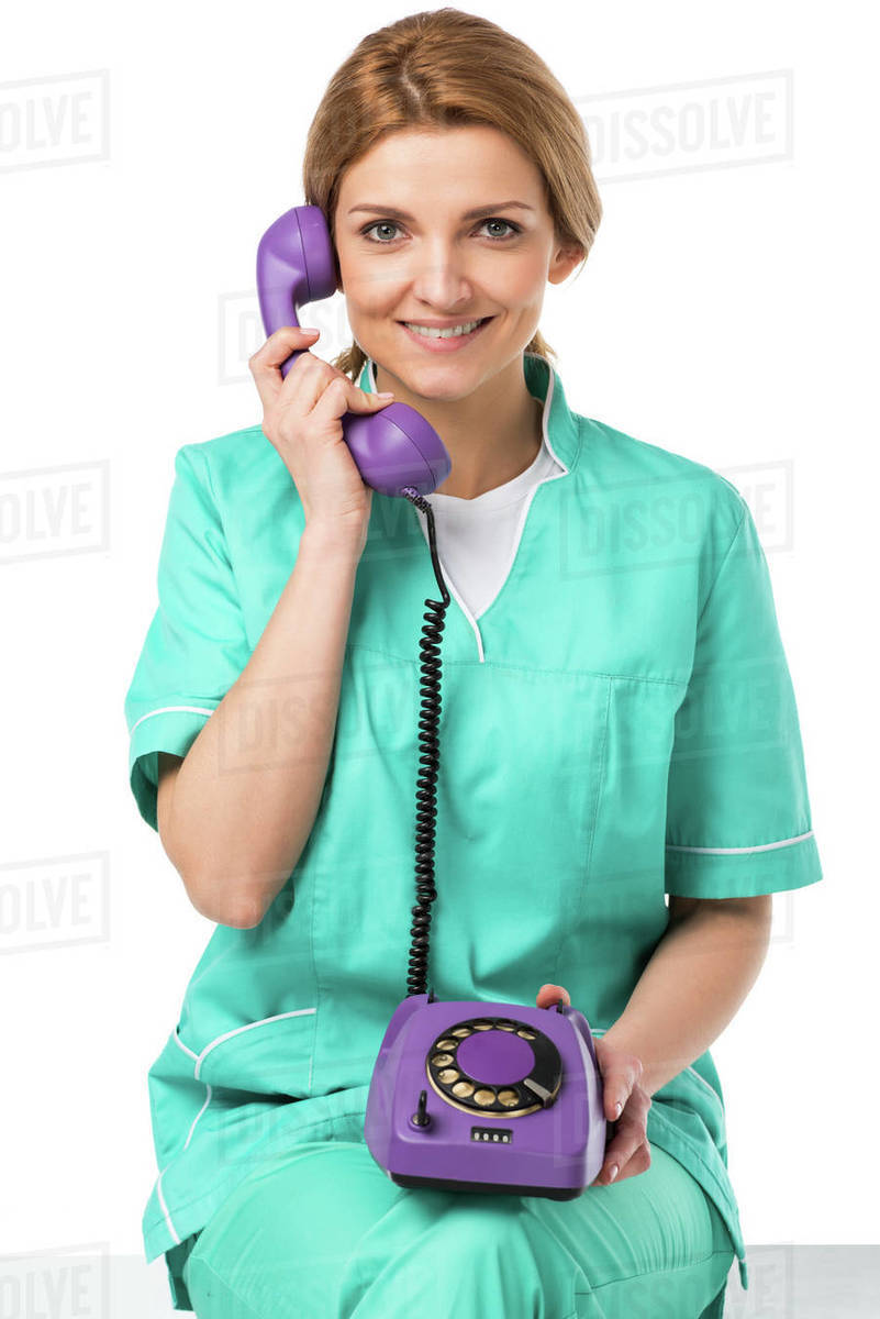 Portrait of smiling veterinarian talking on telephone isolated on white