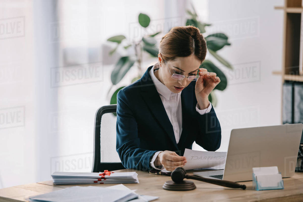 Female lawyer at workplace in office Stock Photo Dissolve