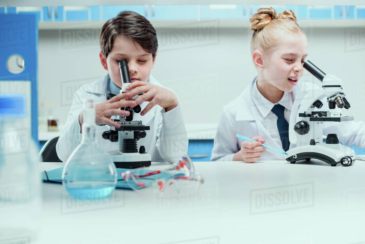 Schoolchildren with science lab equipment in chemical lab, scientists kids group concept Royalty-free stock photo