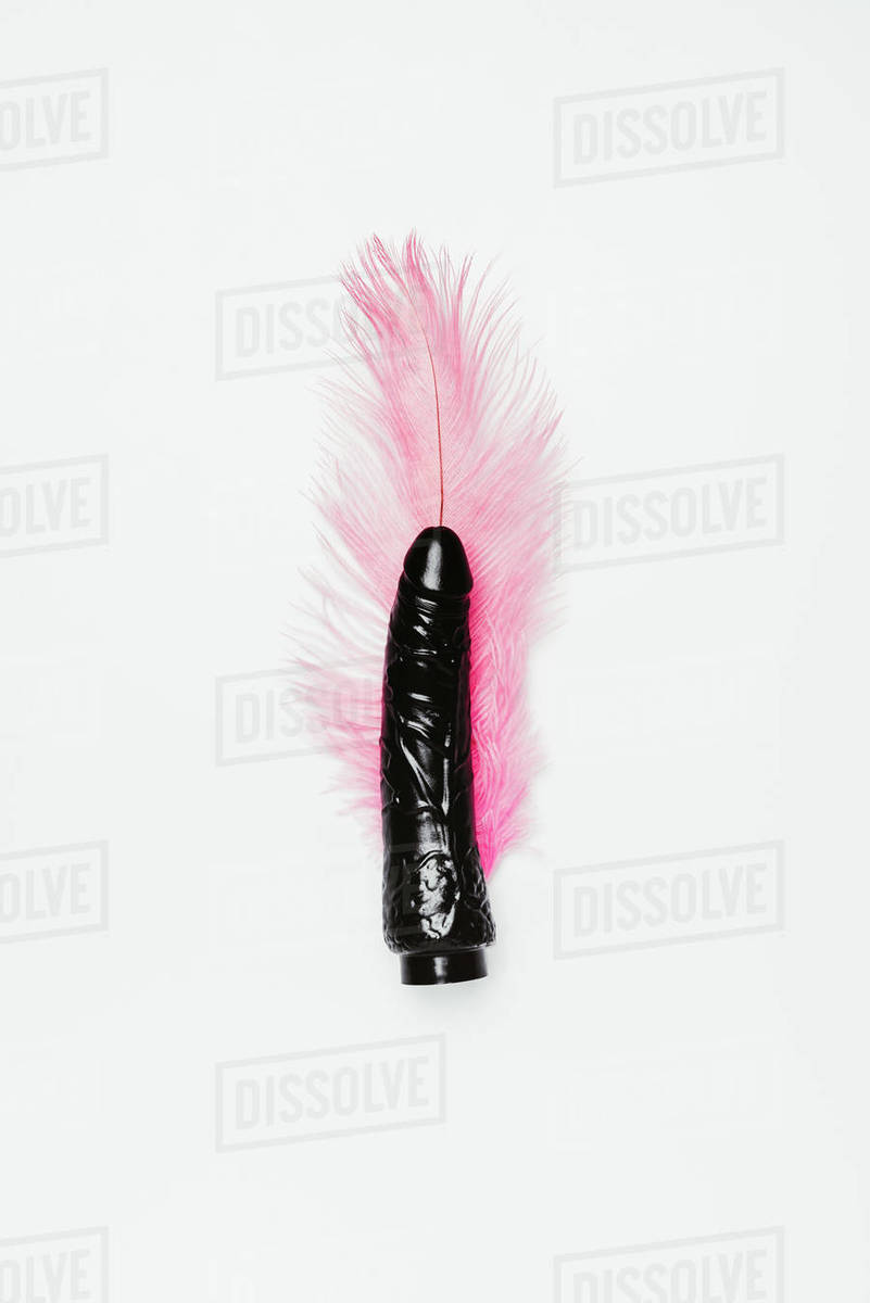 Black dildo toy with pink feather isolated on white - Royalty-free Stock  Photo | Dissolve