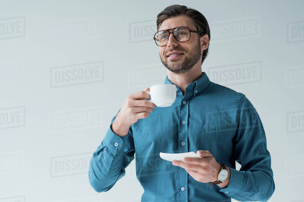 Bottom view of happy young man with cup of coffee isolated on white