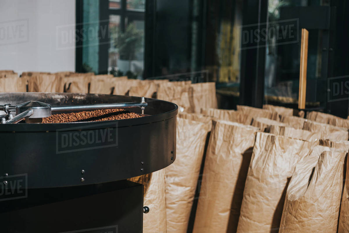 Industrial coffee roaster with large paper bags filled with coffee