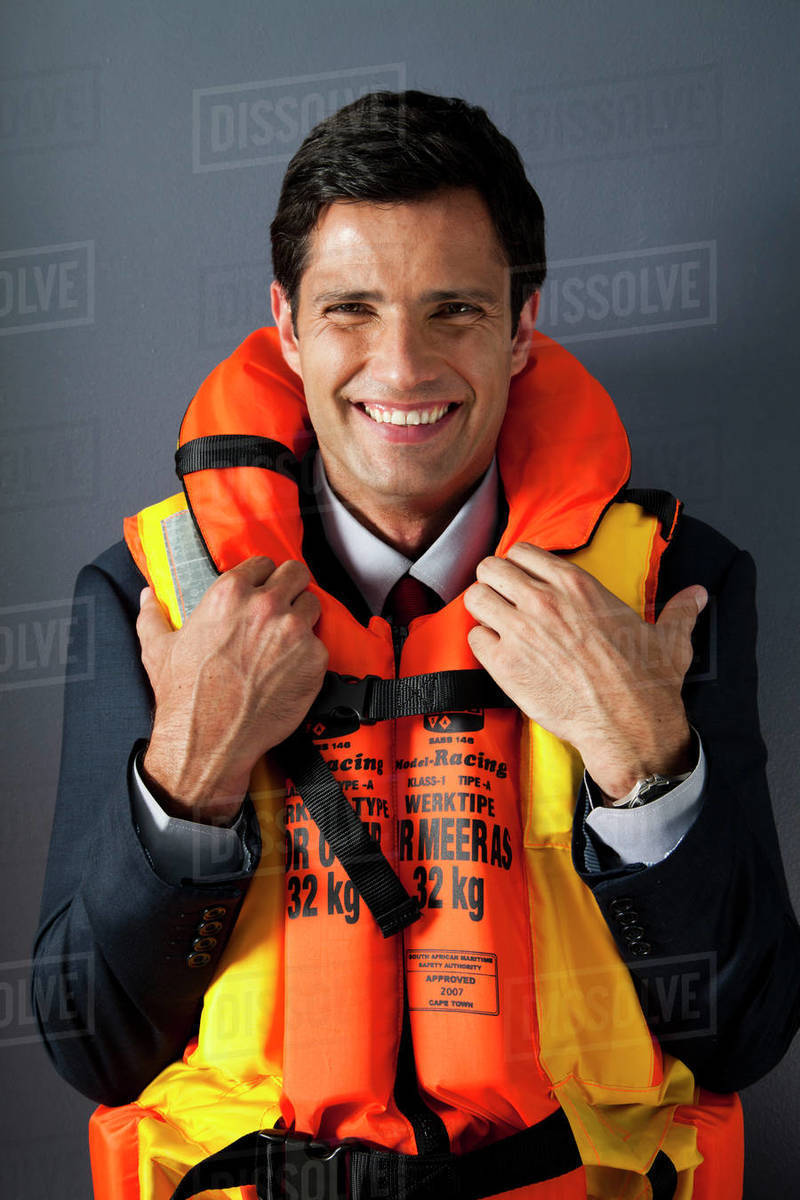Businessman wearing life jacket Stock Photo Dissolve