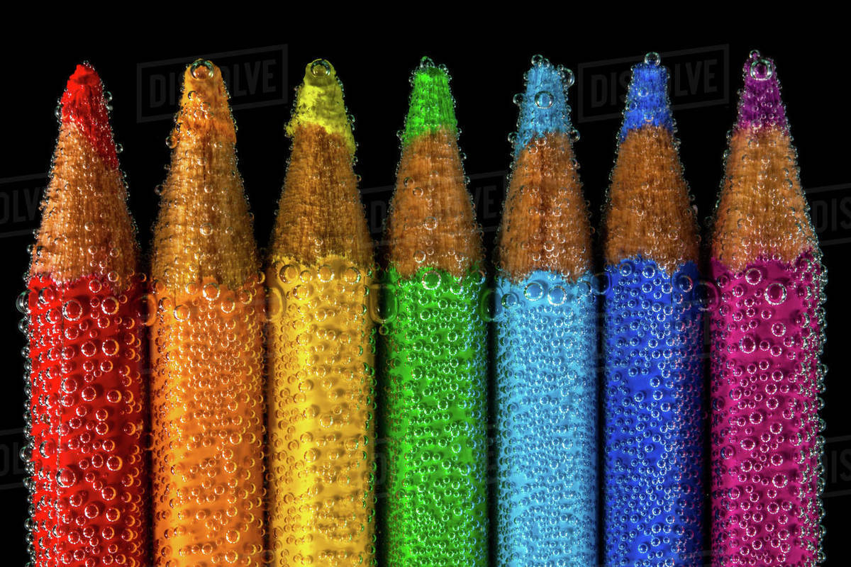 Multi coloured pencils submerged in water Stock Photo Dissolve