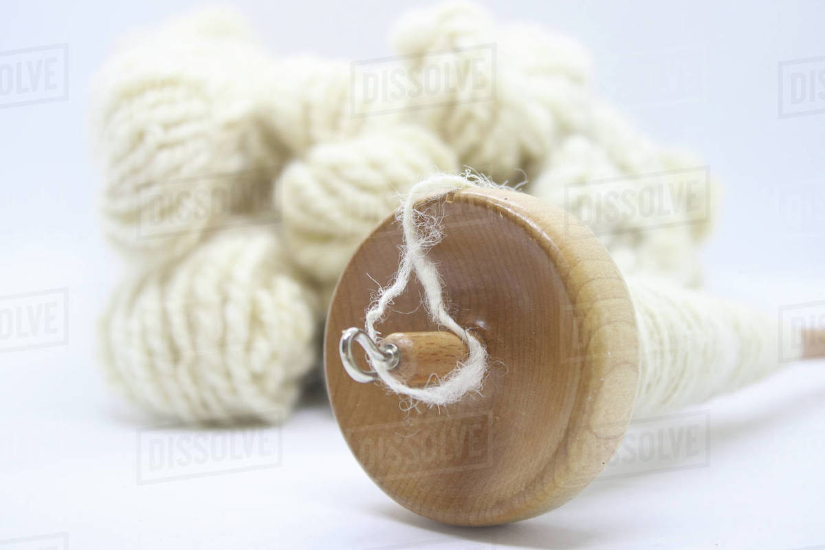 Making wool with a spindle Stock Photo Dissolve