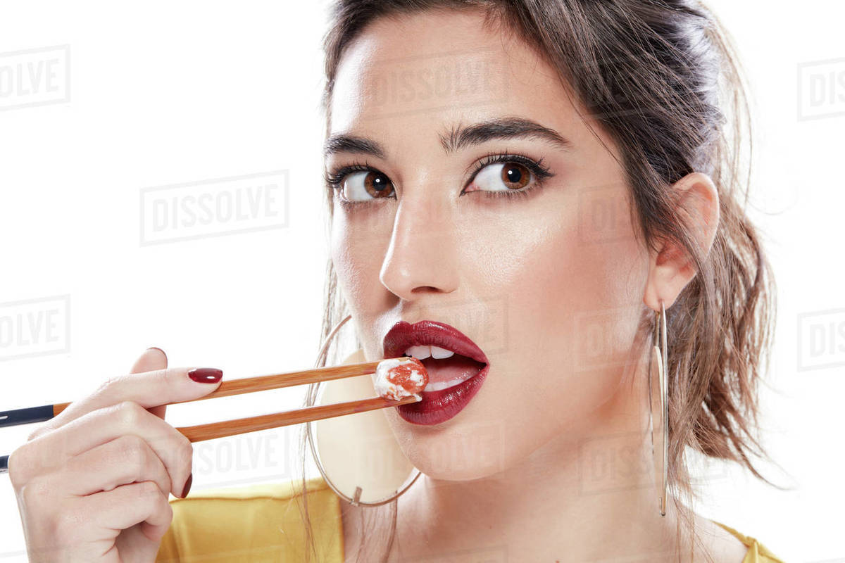 Fancy young woman with red lipstick on opened mouth looking away while