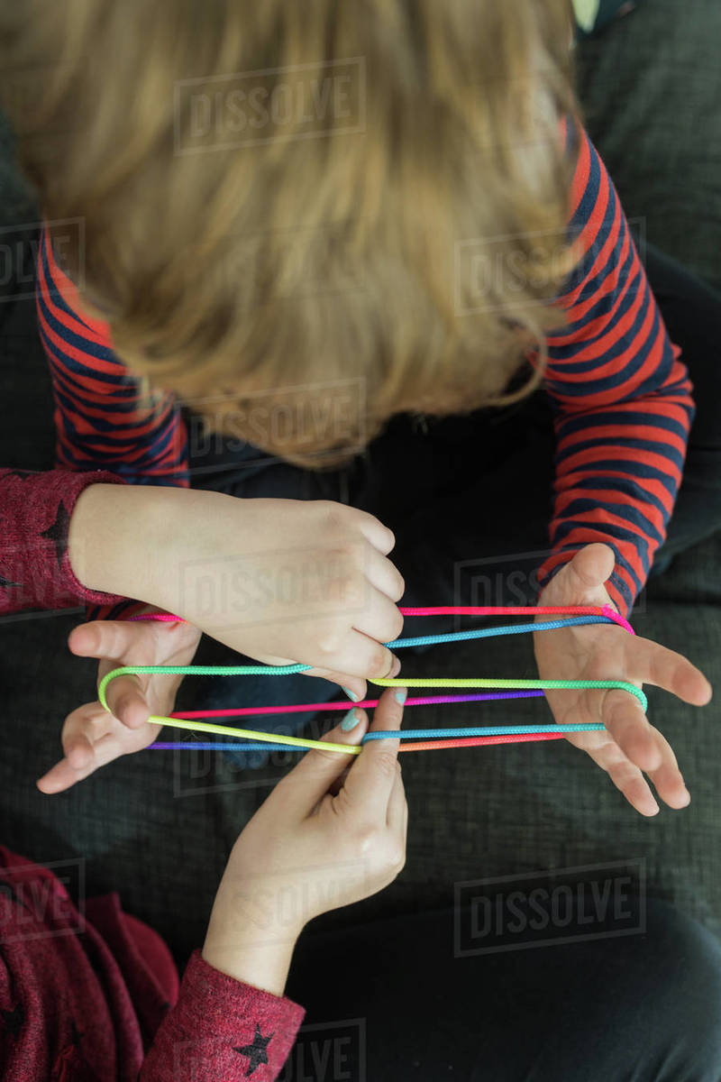 Smart children using rubber bands for game Stock Photo Dissolve