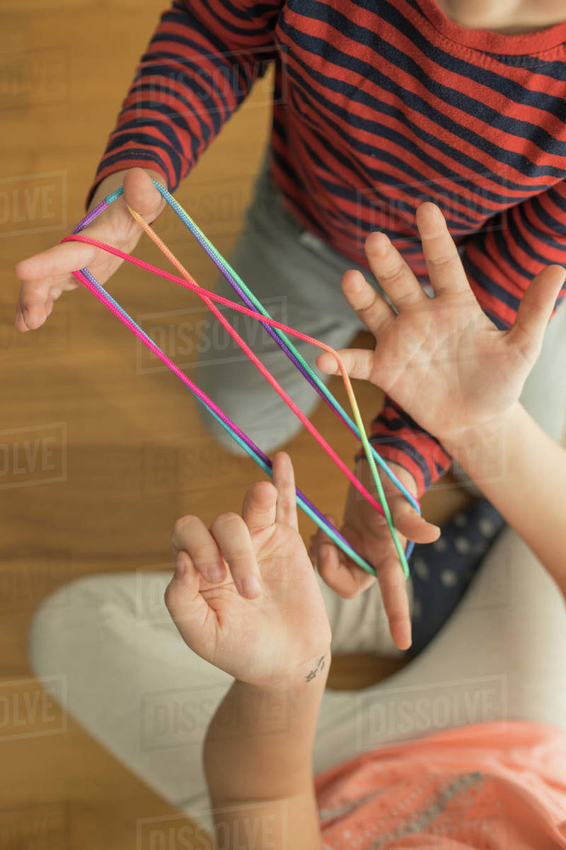 Smart children using rubber bands for game Stock Photo Dissolve