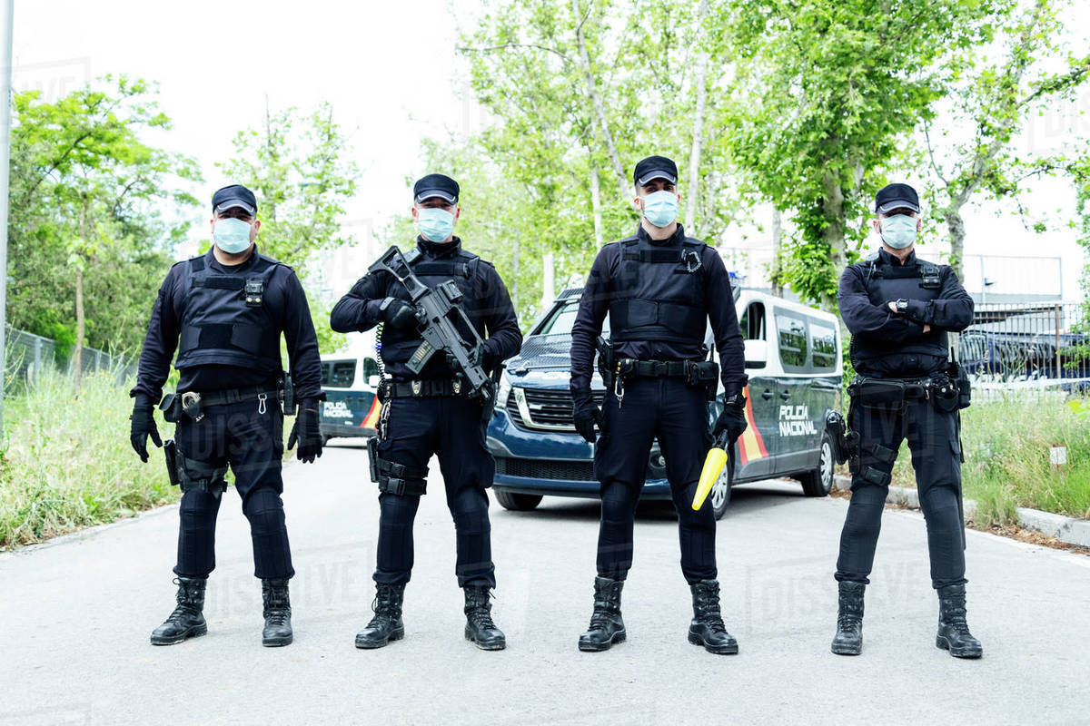 Full body squad of Spanish police officers in protective gears with