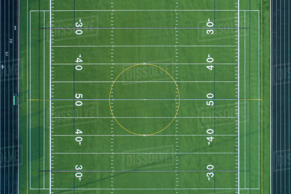 Aerial view of a football field at a suburban high school. Stock