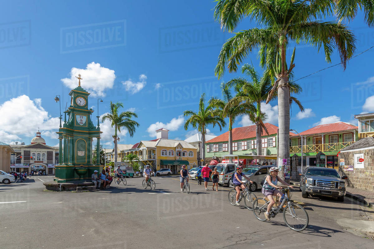 View of cyclists in The Circus and Memorial Clock, Basseterre, St. Kitts and Nevis, West Indies, Caribbean, Central America Royalty-free stock photo